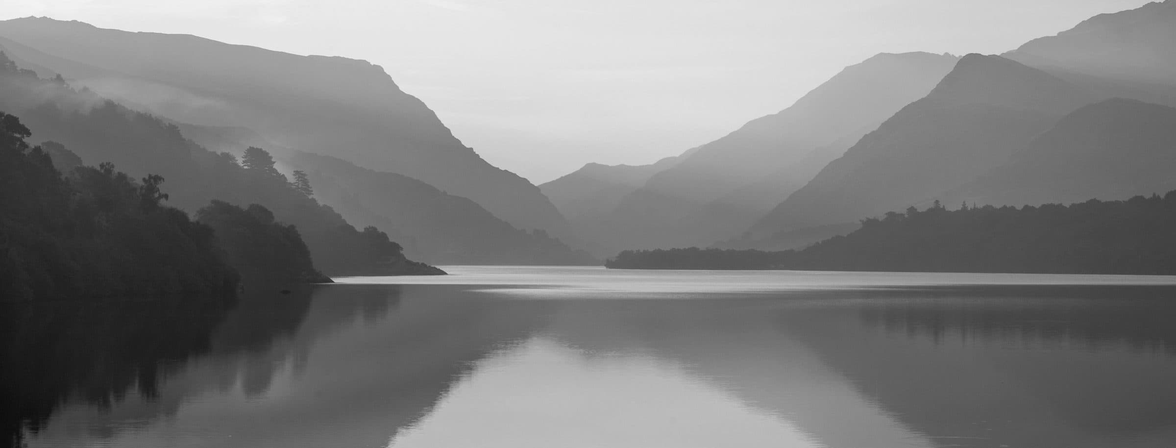 Still water and mountain ridges in Eryri, North Wales.